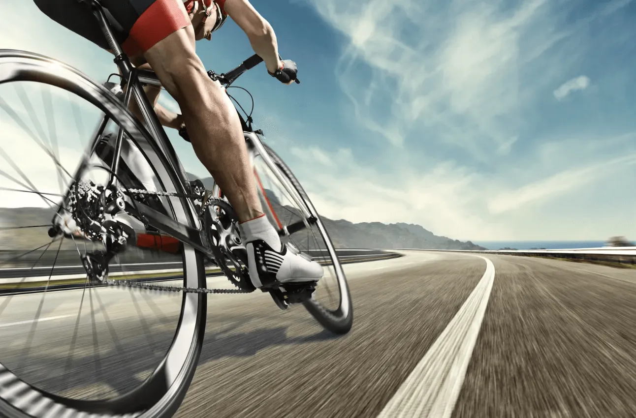 Athlete biking along a paved road